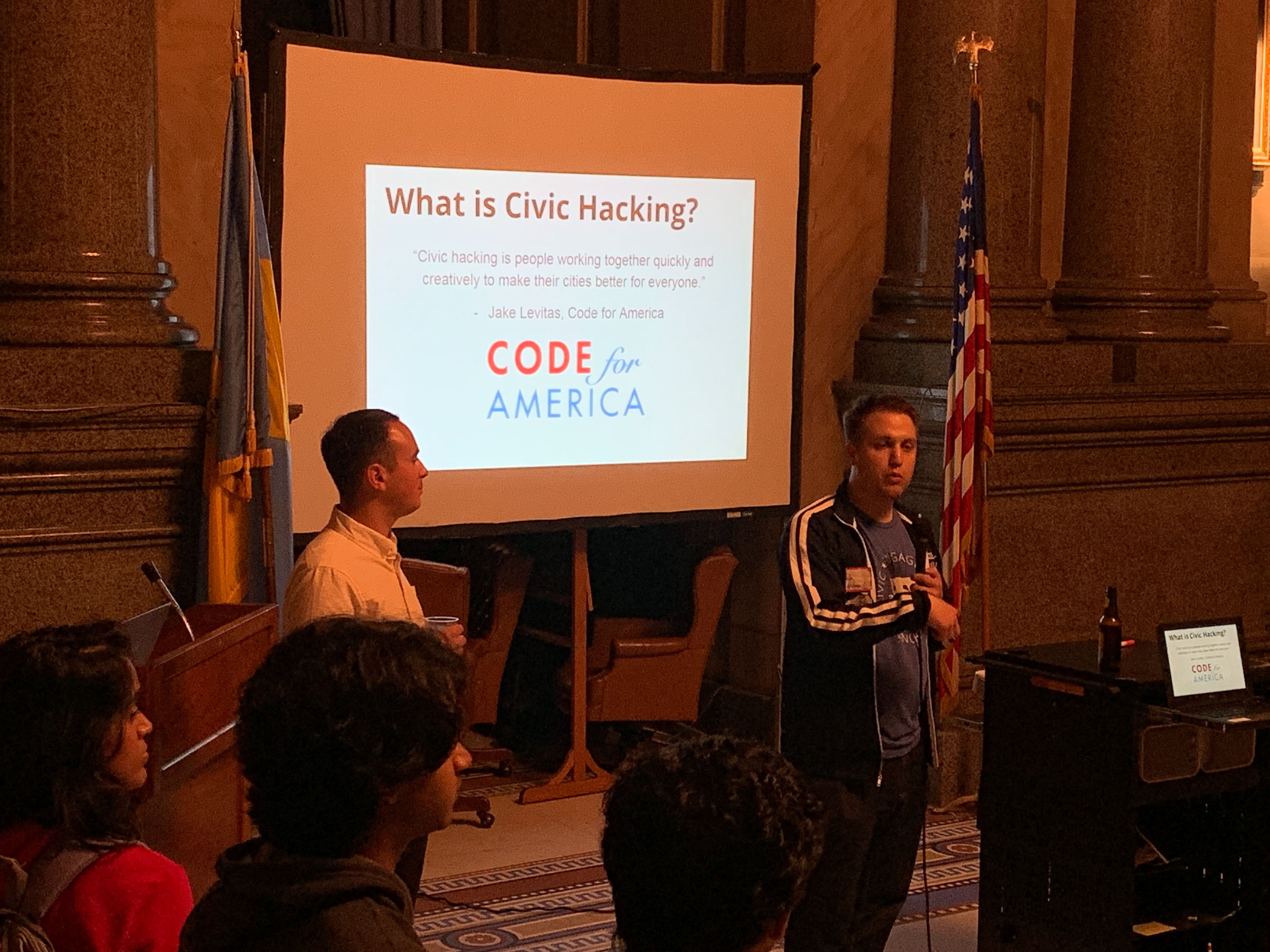 Two people presenting 'What is Civic Hacking?'